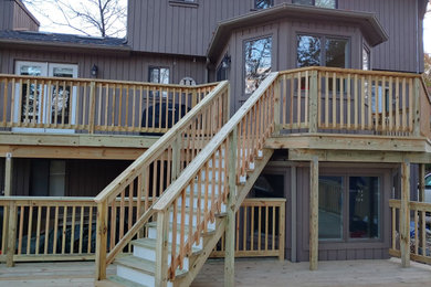 Example of a large classic backyard deck design in New York with no cover
