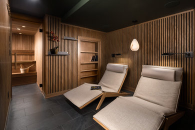 Example of a minimalist wood wall basement design in Milwaukee