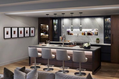 Photo of a medium sized contemporary single-wall kitchen pantry in Detroit with a submerged sink, flat-panel cabinets, blue cabinets, white splashback, integrated appliances, laminate floors, an island, brown floors and grey worktops.