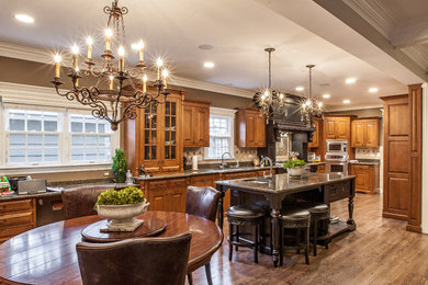 Eat-in kitchen - traditional eat-in kitchen idea in Chicago with raised-panel cabinets and medium tone wood cabinets