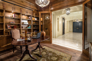 Mid-sized elegant freestanding desk medium tone wood floor study room photo in Los Angeles with white walls