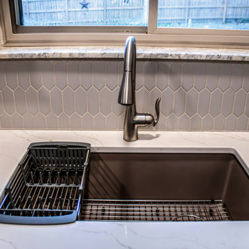 Two-Tone Neutral Kitchen with Quartz Countertop and Soho Picket Backsplash