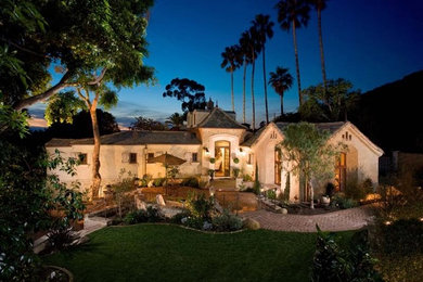 Inspiration for a large coastal beige one-story stucco exterior home remodel in Orange County