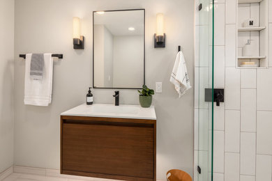 Inspiration for a mid-sized modern 3/4 white tile ceramic tile and multicolored floor bathroom remodel in Seattle with flat-panel cabinets, brown cabinets, a one-piece toilet, a wall-mount sink, quartz countertops, white countertops, a floating vanity and a niche