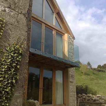 Glass wood balcony and extension, refurbishment of Cotswold stone house