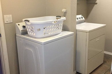 Utility room - small traditional galley ceramic tile utility room idea in Albuquerque with beige walls and a side-by-side washer/dryer