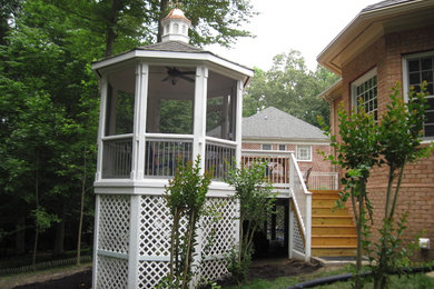 Example of a mid-sized classic backyard patio design in Other with decking and a gazebo