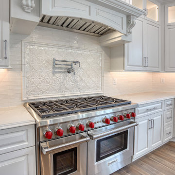 Transitional Kitchen with Two Toned Gathering Island & Archways