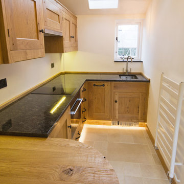 A Guesthouse With A Small Yet Beautiful Oak Kitchen And Cloakroom
