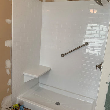 Install bench seat and brushed nickel grab bar