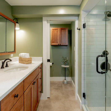 Family-Friendly Basement Bathroom with Transitional Wood Vanity and Sage Walls