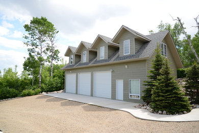 Example of a large arts and crafts gray two-story wood gable roof design in Other