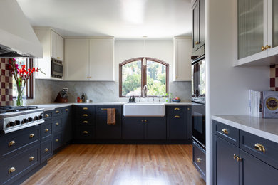 Large transitional l-shaped eat-in kitchen photo in Los Angeles with shaker cabinets