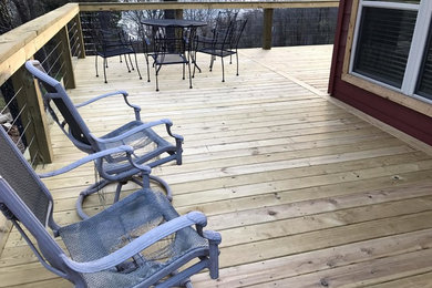 Large elegant backyard deck photo in Other with no cover