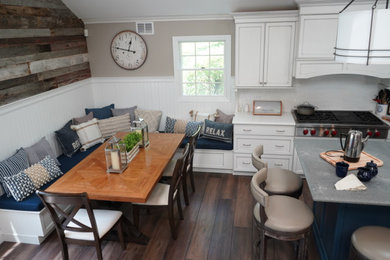 Open concept kitchen - large country l-shaped vinyl floor and brown floor open concept kitchen idea in New York with a double-bowl sink, recessed-panel cabinets, white cabinets, quartz countertops, white backsplash, subway tile backsplash, stainless steel appliances, an island and gray countertops