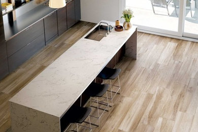 Kitchen - large transitional porcelain tile kitchen idea in Minneapolis with an undermount sink, flat-panel cabinets, dark wood cabinets, marble countertops and an island