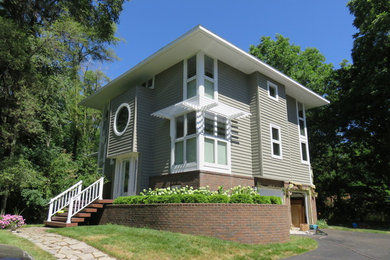 Inspiration for a large transitional gray two-story exterior home remodel in Detroit