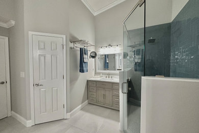 Walk-in shower - large transitional master blue tile and glass tile porcelain tile, white floor and single-sink walk-in shower idea in Jacksonville with gray cabinets, an undermount sink, quartz countertops, a hinged shower door, white countertops and a freestanding vanity