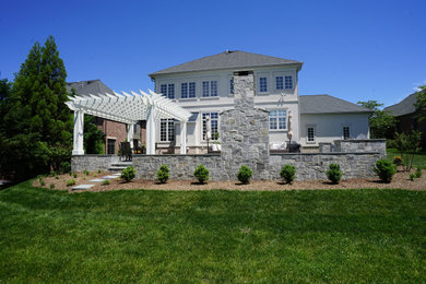 Patio - mid-sized transitional stone patio idea in DC Metro with a fireplace