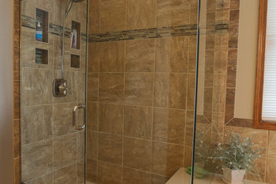 Arts and crafts glass tile dark wood floor bathroom photo in Denver with beige walls
