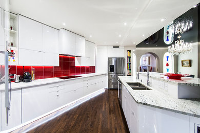 Mid-sized contemporary galley eat-in kitchen in Montreal with an undermount sink, flat-panel cabinets, white cabinets, granite benchtops, red splashback, glass tile splashback, stainless steel appliances, dark hardwood floors and a peninsula.