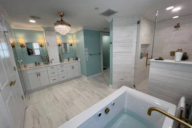 Inspiration for a large 1950s master green tile and marble tile marble floor, multicolored floor and double-sink bathroom remodel in Tampa with flat-panel cabinets, white cabinets, a one-piece toilet, green walls, an undermount sink, quartzite countertops, a hinged shower door, white countertops and a built-in vanity