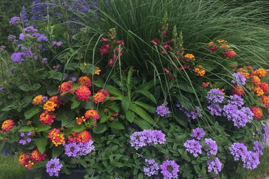 This is an example of a large traditional full sun backyard landscaping in New York for summer.