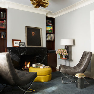 ニューヨークのモダンスタイルのおしゃれな書斎 (カーペット敷き、標準型暖炉、石材の暖炉まわり、グレーの床) の写真