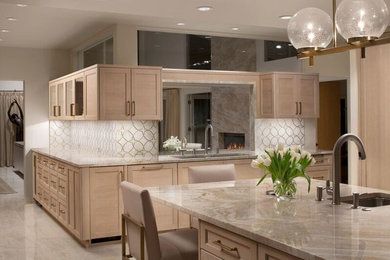 Inspiration for a large contemporary travertine floor open concept kitchen remodel in Baltimore with an undermount sink, shaker cabinets, light wood cabinets, quartzite countertops, multicolored backsplash, mosaic tile backsplash, stainless steel appliances and an island