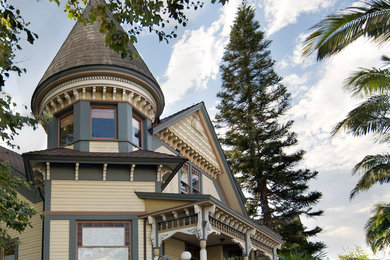 Inspiration for a mid-sized traditional two-storey beige house exterior in Santa Barbara with wood siding, a gable roof and a shingle roof.