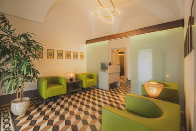 Immagine di un ingresso minimalista di medie dimensioni con pareti beige, pavimento con piastrelle in ceramica, una porta singola, una porta in legno bruno e soffitto a volta