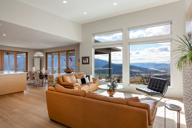 Example of a mid-sized minimalist open concept light wood floor living room design in Vancouver with white walls