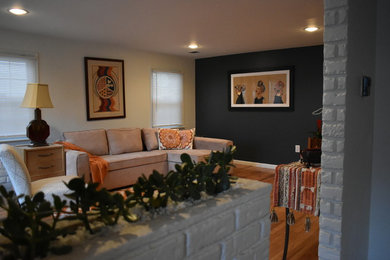 Example of a mid-century modern living room design in Other with blue walls