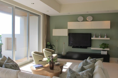 Family room - contemporary open concept marble floor family room idea in Miami with green walls, no fireplace and a wall-mounted tv