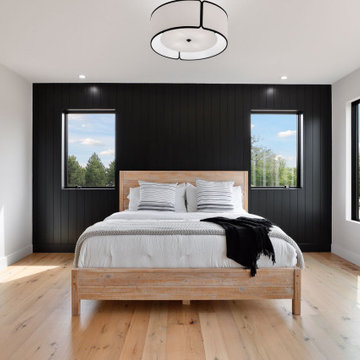 Antique White Oak Flooring in a Contemporary Bedroom with Black Accent Wall