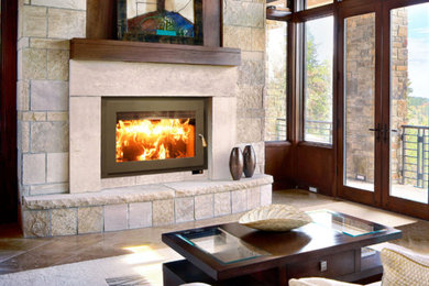 Example of a mid-sized transitional enclosed travertine floor and beige floor family room design in Denver with a standard fireplace, a stone fireplace and no tv