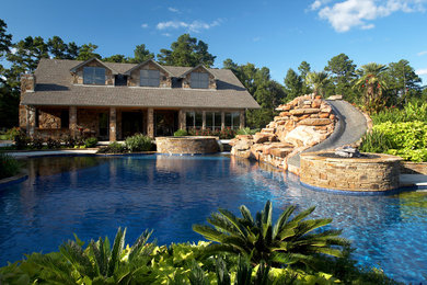 Design ideas for a large craftsman full sun backyard stone water fountain landscape in New Orleans for summer.