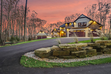 Huge arts and crafts beige two-story mixed siding house exterior photo in Grand Rapids with a clipped gable roof and a shingle roof