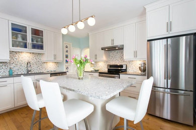 Inspiration for a mid-sized contemporary l-shaped dark wood floor and brown floor eat-in kitchen remodel in Other with an undermount sink, shaker cabinets, white cabinets, granite countertops, multicolored backsplash, mosaic tile backsplash and stainless steel appliances