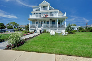 Large beach style three-storey house exterior in Other.