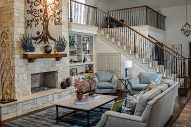 Mid-sized mountain style open concept medium tone wood floor and brown floor living room photo in Dallas with white walls, a standard fireplace, a stone fireplace and no tv