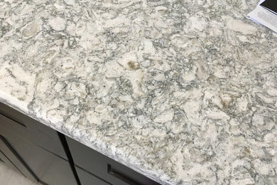 Example of a small transitional u-shaped porcelain tile and white floor kitchen design in Cincinnati with shaker cabinets, quartzite countertops, stainless steel appliances and a peninsula