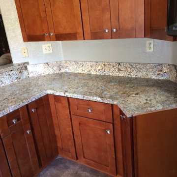 Kitchen cinnamon shaker cabinets with sparking quartz countertops
