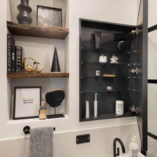 Inspiration for a small modern white tile and porcelain tile porcelain tile, black floor, single-sink, wallpaper ceiling and wainscoting bathroom remodel in Chicago with furniture-like cabinets, brown cabinets, a one-piece toilet, white walls, an integrated sink, solid surface countertops, white countertops, a niche and a freestanding vanity
