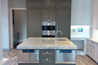 Mid-sized transitional l-shaped porcelain tile and brown floor eat-in kitchen photo in New York with an undermount sink, beaded inset cabinets, white cabinets, white backsplash, stainless steel appliances, an island and granite countertops