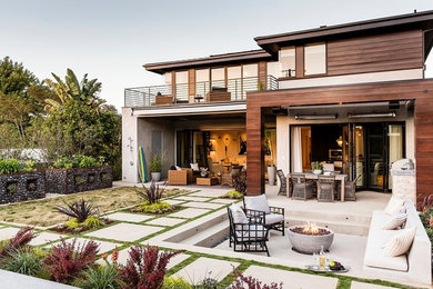 Design ideas for a contemporary two-storey exterior in Los Angeles with wood siding and a flat roof.