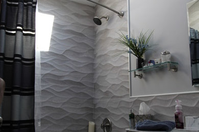 Mid-sized transitional gray tile and porcelain tile porcelain tile bathroom photo in Philadelphia with shaker cabinets, a console sink, dark wood cabinets, marble countertops, a two-piece toilet and gray walls