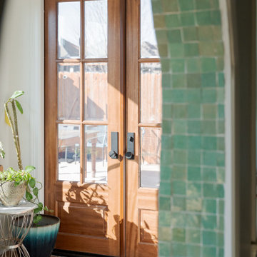 Arched Built-Ins Meet Terracotta Tile in a Light-Filled Sunroom Addition
