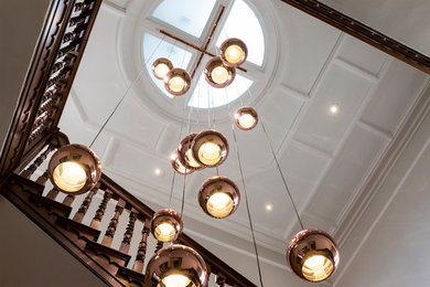 Design ideas for an expansive contemporary wood straight wood railing staircase in London with wood risers.