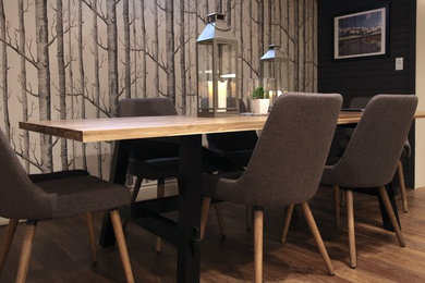 Mid-sized mountain style vinyl floor and brown floor dining room photo in Other with gray walls